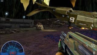 Image from the video game Aliens vs. Predator 2. It's a first person shooter. On the bottom left is a blue radar screen and an ammo count. On the bottom right is a chunky, green rifle in 'your' hands. In the distance you can see a crashed green spaceship.