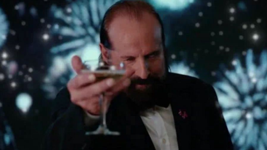 Peter Stormare replaces Leonardo DiCaprio in the popular Great Gatsby meme, lifting a glass of champaigne as fireworks detonate behind him. He is wearing a black suit jacket and white button down shirt. A three-headed Cerberus pin for Black Ops 6 is on the jacket&#039;s lapel.