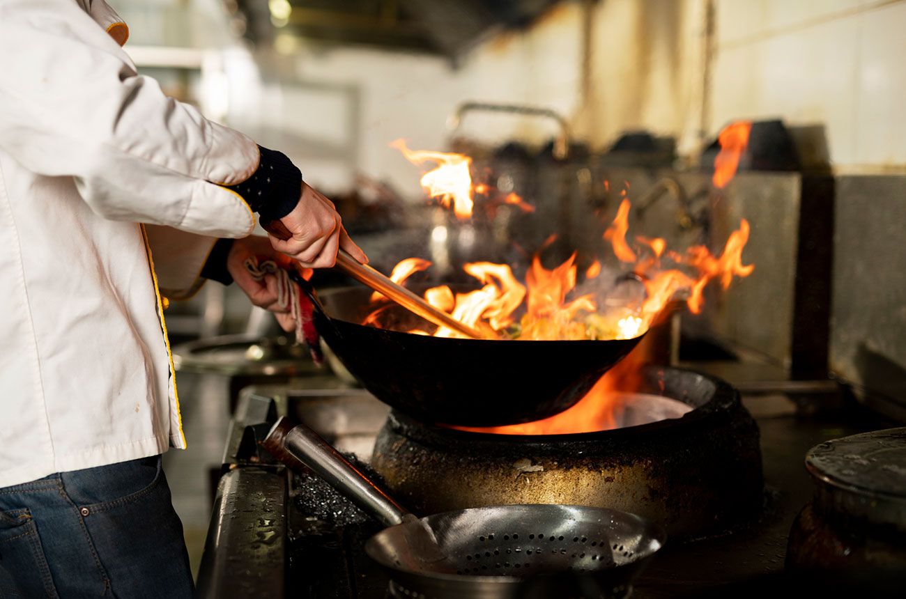 wok cooking over flames