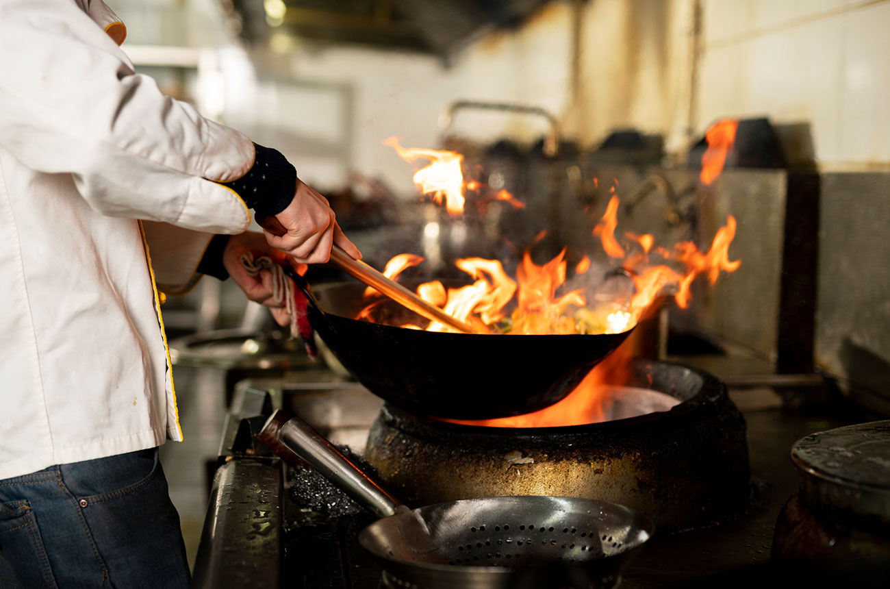 wok cooking over flames