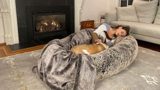 Woman lying in Plufl dog bed for humans