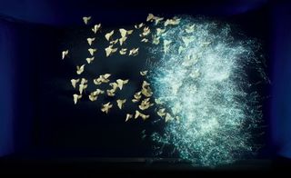 Floating origami butterflies with an explosion of water