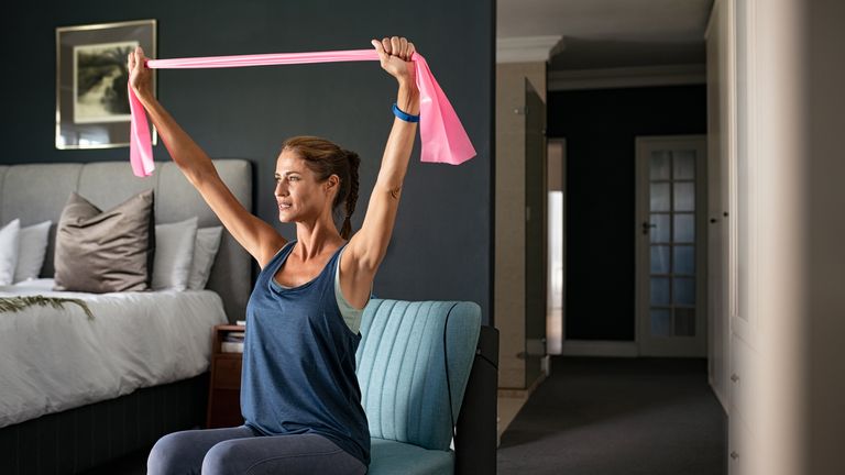 Woman trains her triceps using a resistance band