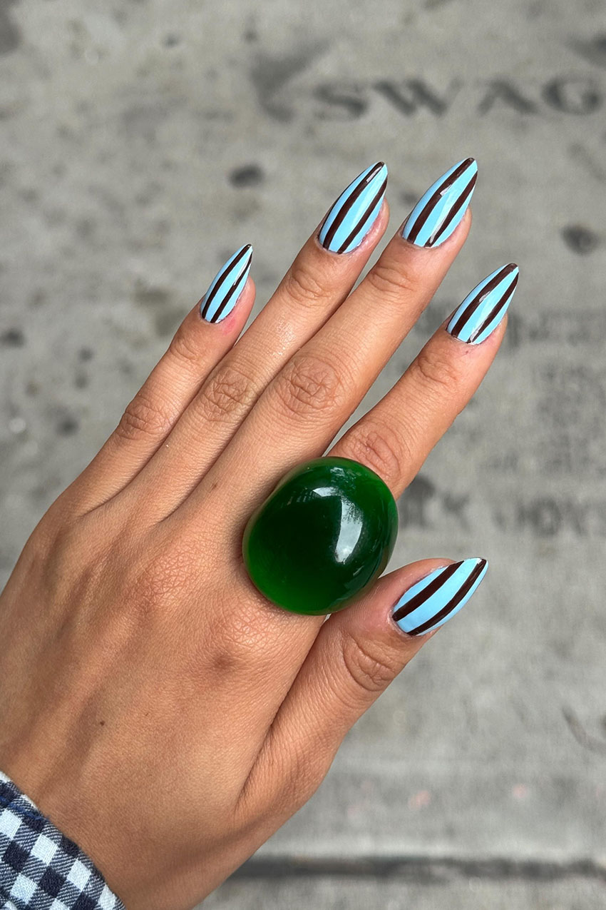 a woman wearing a green gem ring
