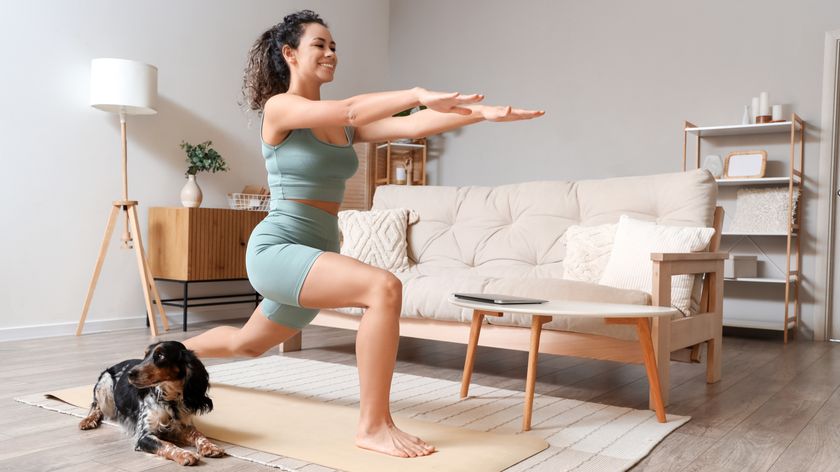 a woman working out on an exercise mat with her dog sat beside her