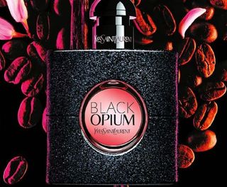 Image of best selling Black Opium bottle on a dark red floral background for Cyber Monday deals