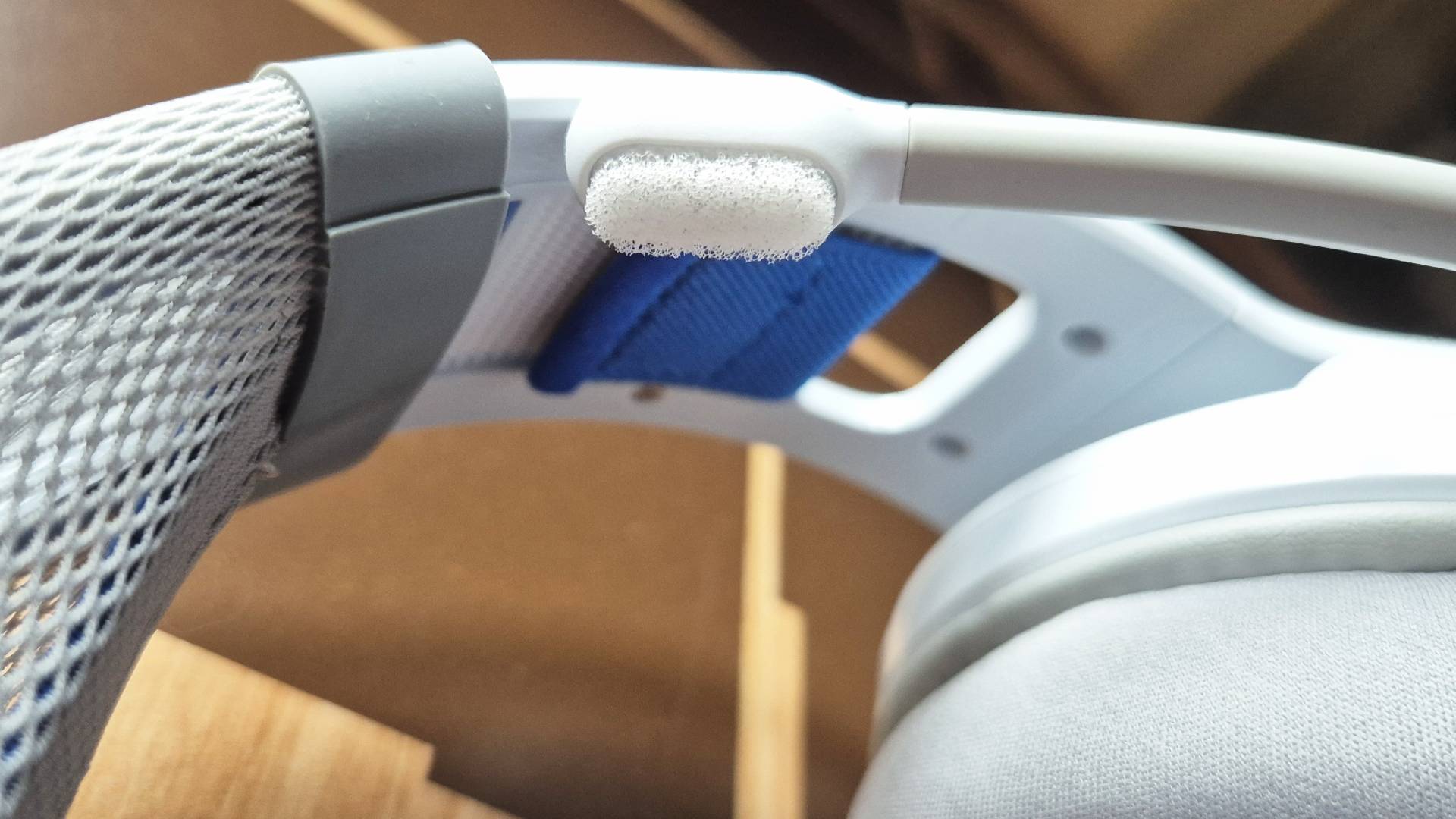 Photo featuring a close up to a white headset microphone.