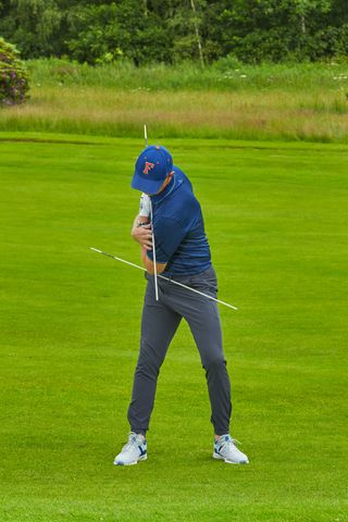 Ged Walters using alignment sticks to demonstrate the fundamental movements in the iron swing