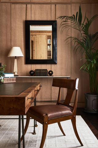 Wooden and brown study room with white rug and plant
