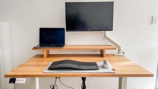 Desky Dual Hardwood standing desk with laptop, monitor and peripherals