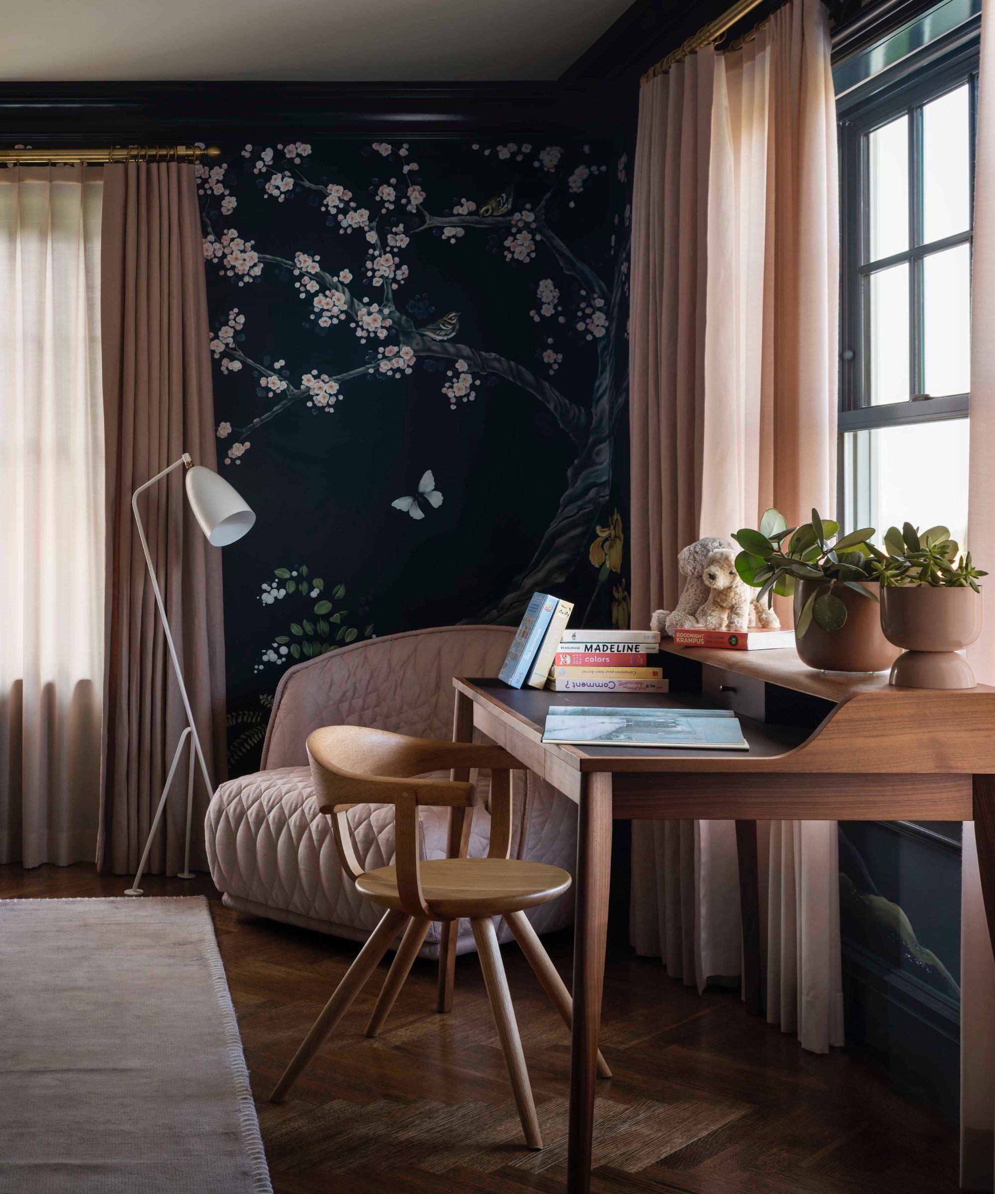 navy and floral wallpapered bedroom with a desk
