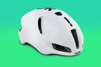 Kask Utopia road bike helmet pictured front side on with a green background