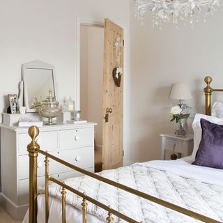 bedroom with wooden door and white drawer