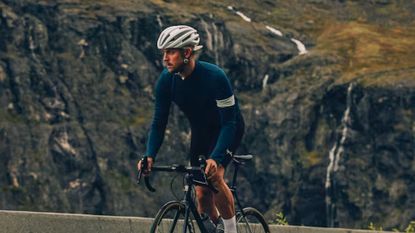 Male rider wearing the Rapha Classic Long Sleeved jersey with mountain back drop