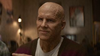 Unmasked Wade Wilson smiling in a cardigan at the end of Deadpool & Wolverine. 