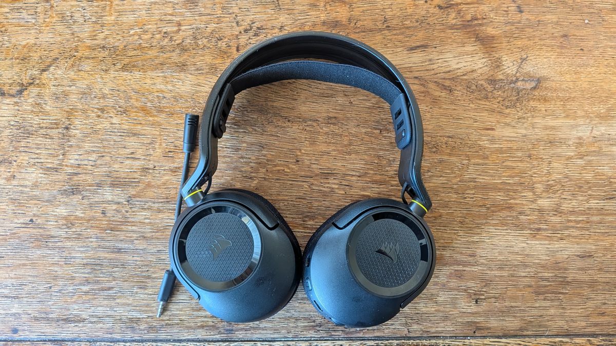 A gaming headset laid flat on a wooden surface