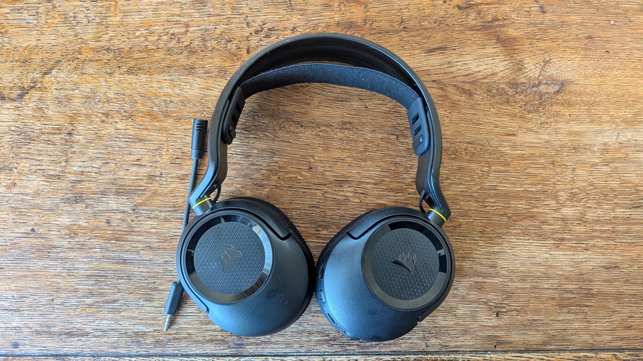 A gaming headset laid flat on a wooden surface