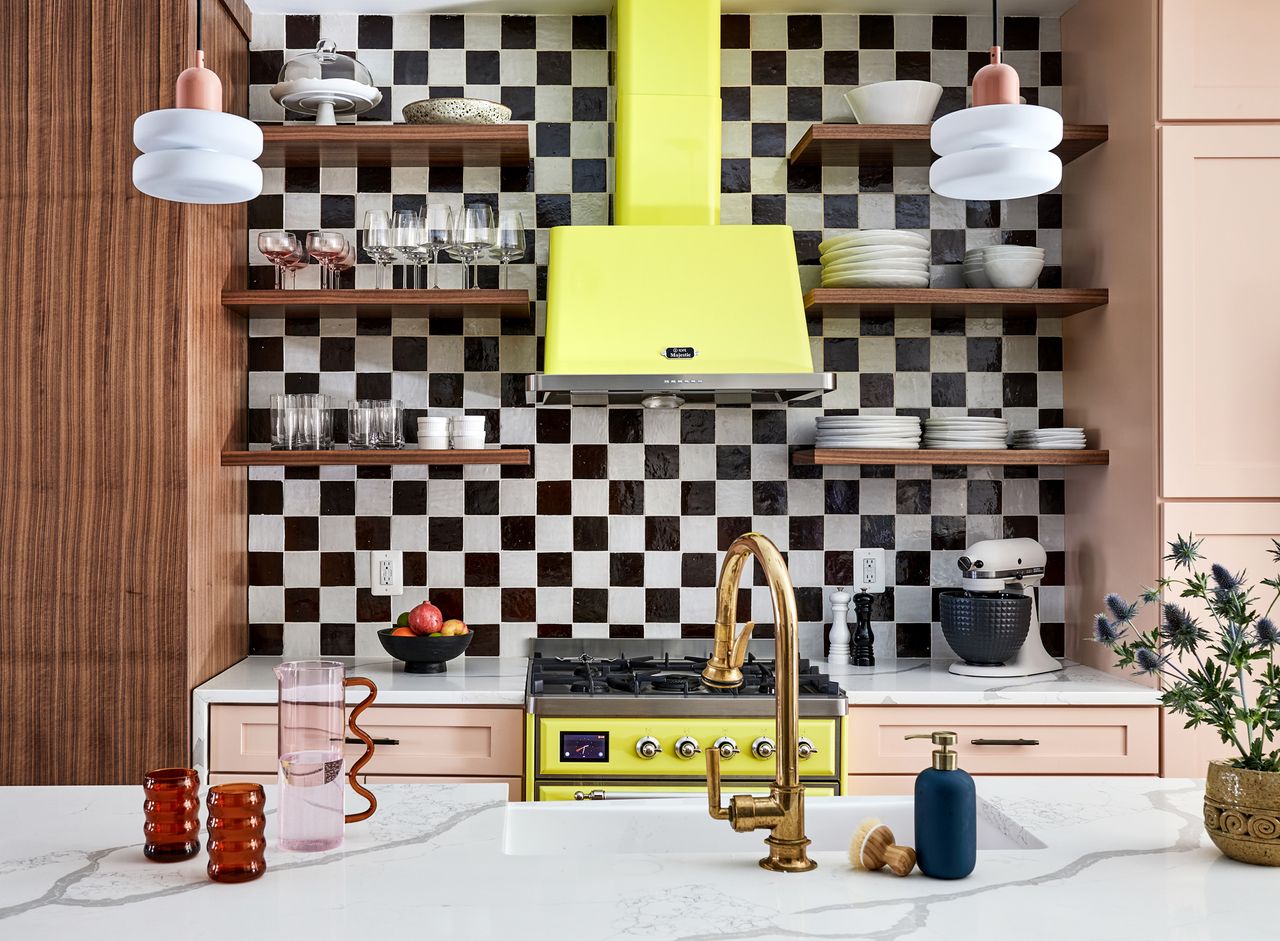 a kitchen with a checkerboard backsplash and neon yellow range cooker
