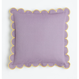 lilac pillow with scalloped border and yellow contrast rim