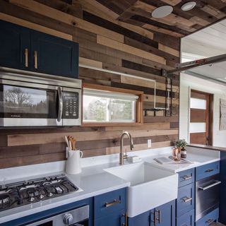 kitchen area with blue drawers and oven