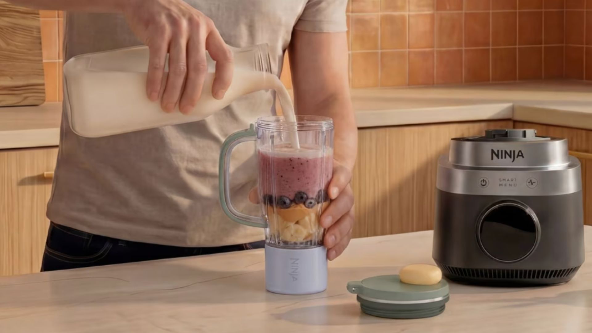 Ninja CrushBOSS 3-in-1 Kitchen System on the counter making a smoothie