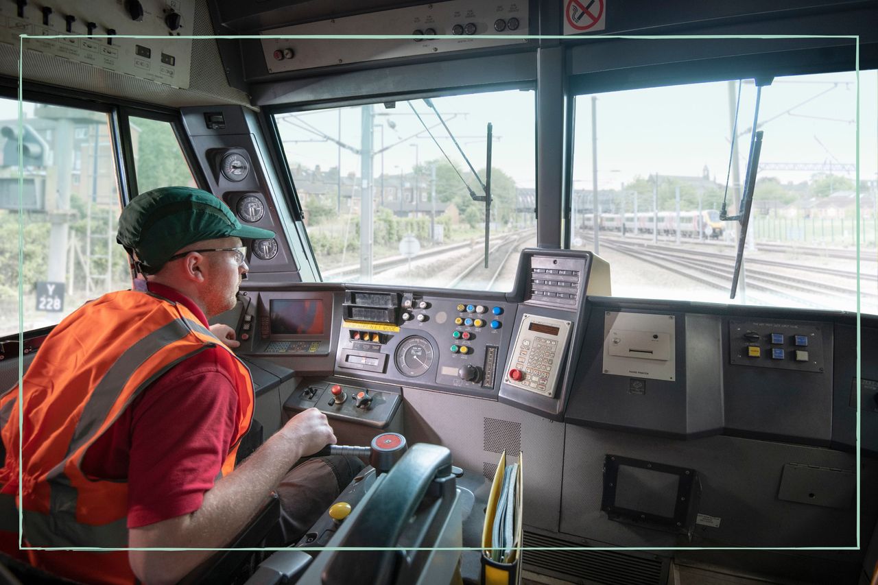 The inside of a train with a train driver working