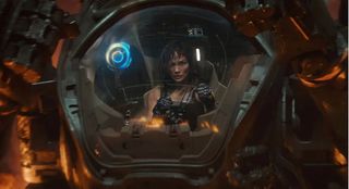 a woman in a cockpit steers her giant robot
