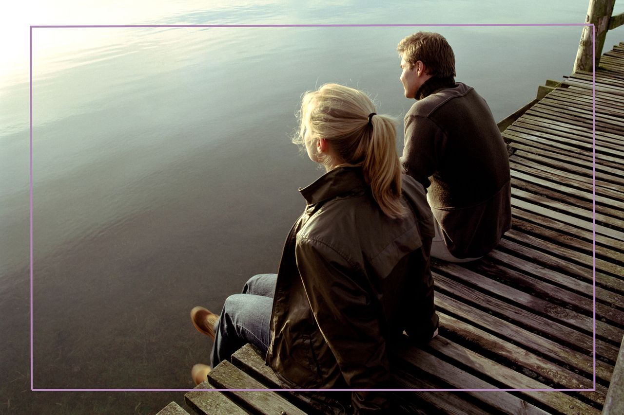 Man and woman looking out across water