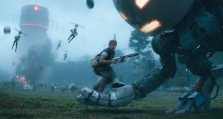 an armed man gets picked up by a giant robot as flying drones attack