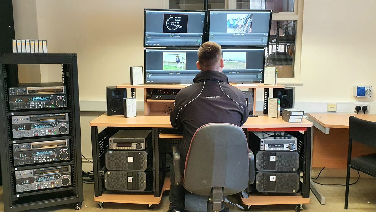 A man sitting in front of several control monitors with CJP Broadcast solutions.