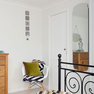 room with white walls and mirror on wall