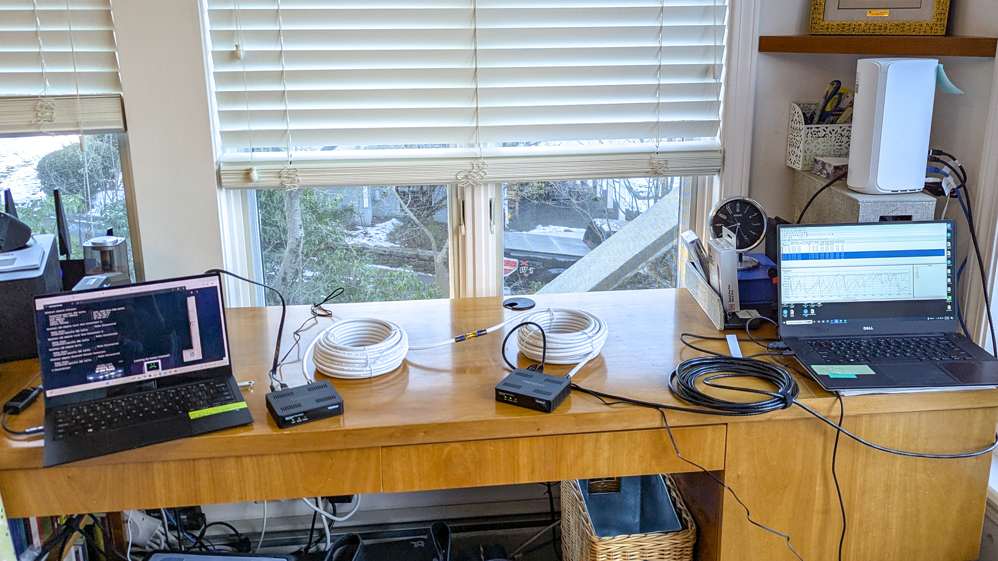 Two laptops connected to each other on coaxial cable using two moca adapters