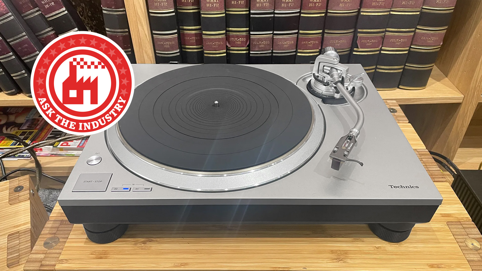 Technics turntable on a hi-fi rack with an Ask The Industry roundel on it