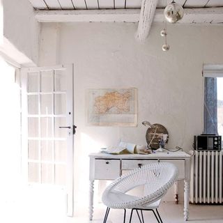 white living space with table and wooden ceiling