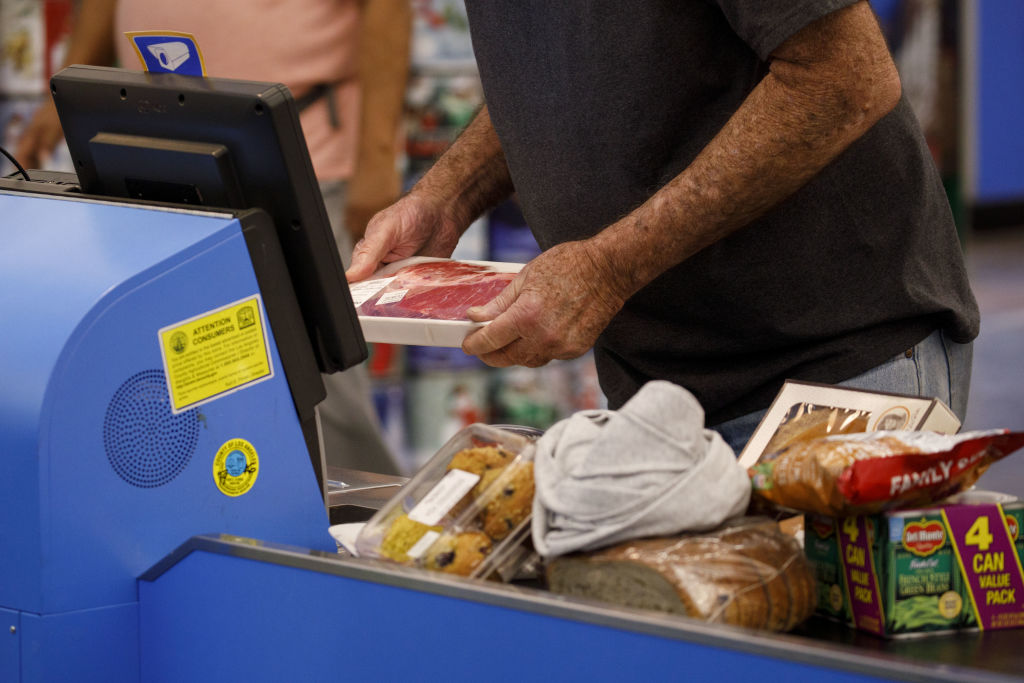 Man scanning groceries at self check out