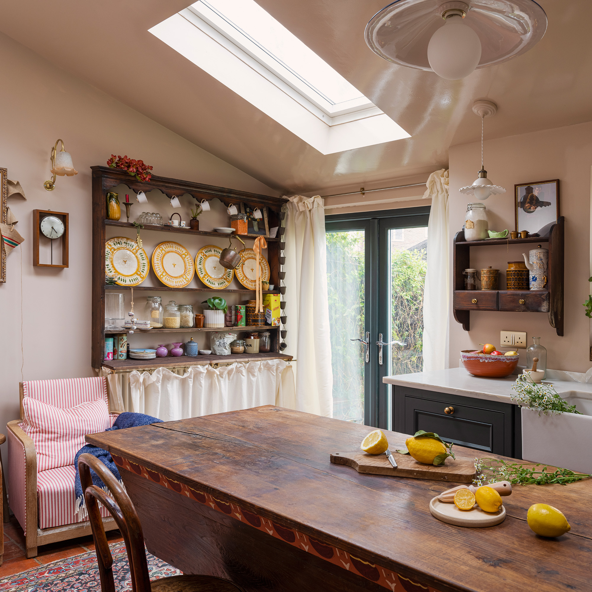 vintage style kitchen with dresser unique with vintage plates mugs and storage tins and a wooden reclaimed feature island