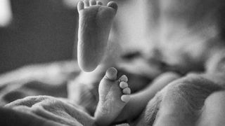 tiny baby feet in black and white