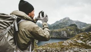 Man with phone in mountains