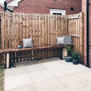 outdoor kitchen makeover with wooden fencing and cup