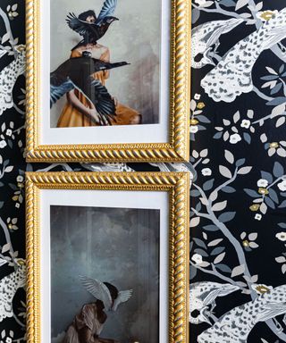 Two framed paintings on a wallpapered wall