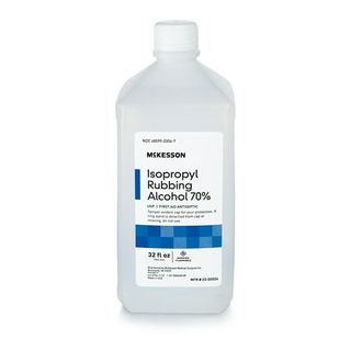 A clear bottle of Mckesson Isopropyl Rubbing Alcohol with white, black and blue label