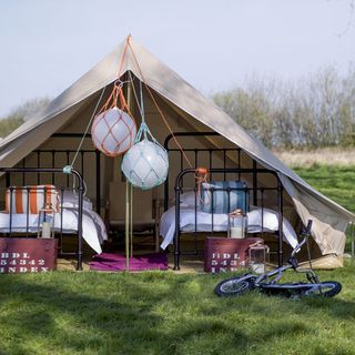 tent with bicycle and beds