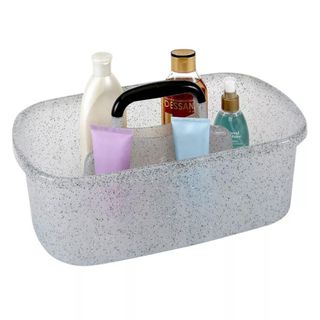A granite storage caddy box filled with shower items