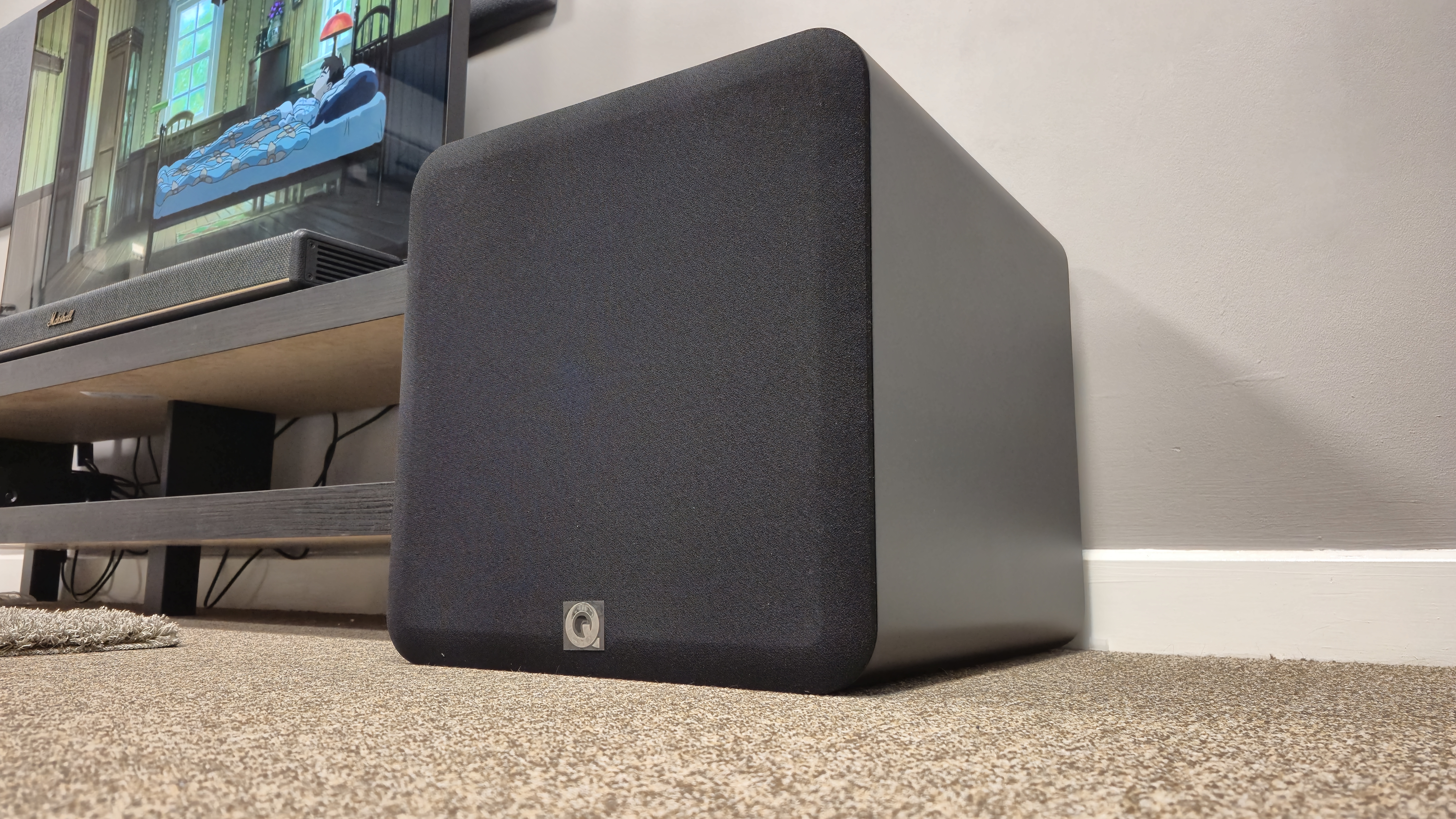 Q Acoustics Q Sub120 on floor next to TV cabinet