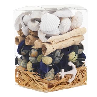 glass jar with shells and pebbles with driftwood