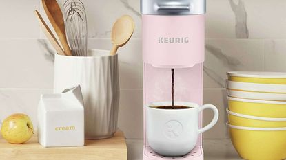 A pastel pink Keurig K-Mini single-serve coffee-making machine