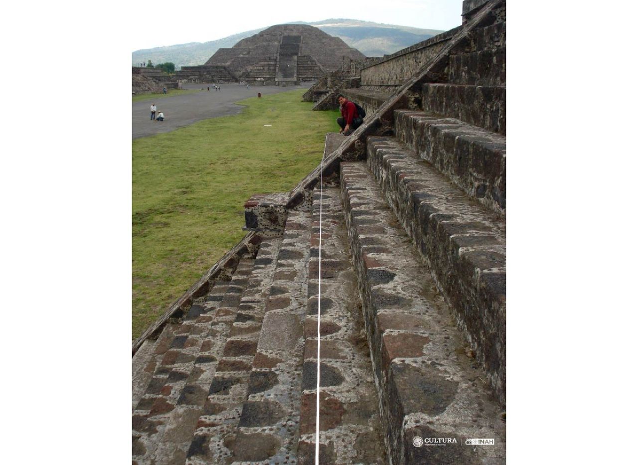 A man sits on the steps of a pyramid