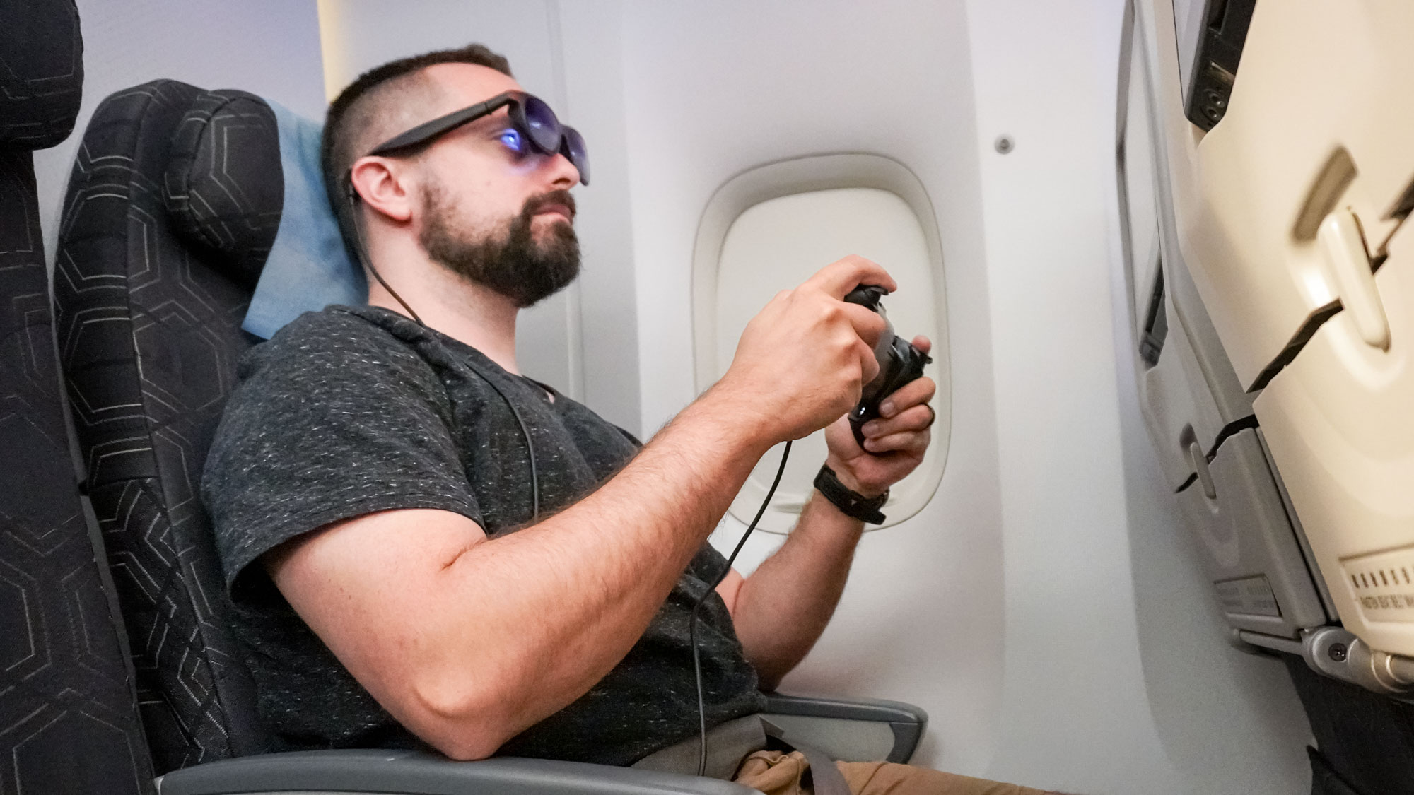Playing games on the Viture x 8BitDo Ultimate Mobile Gaming Controller on an airplane