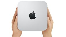 Best Mac Mini deals 2023, image shows Mac mini held in hands