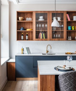 Wooden shelves, blue base cabinets, wooden kitchen island